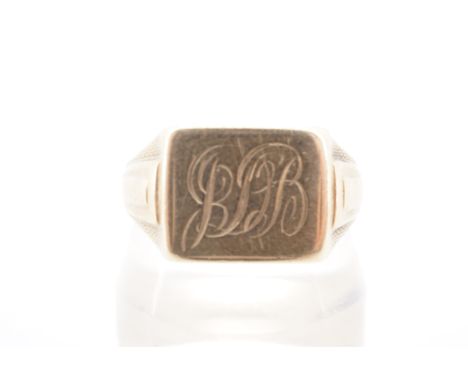 A 1950s 9 ct gold signet ring, having an oblong face set between terraced and engine-turned shoulders, T / U, 3.8 g