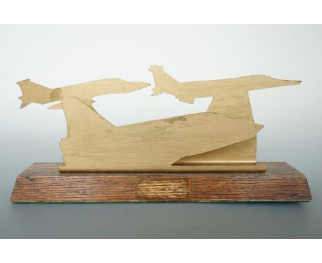 A "trench art" brass letter rack in the form of silhouetted RAF Lightning and other jet aircraft, engraved "RAF Leconfield, 1