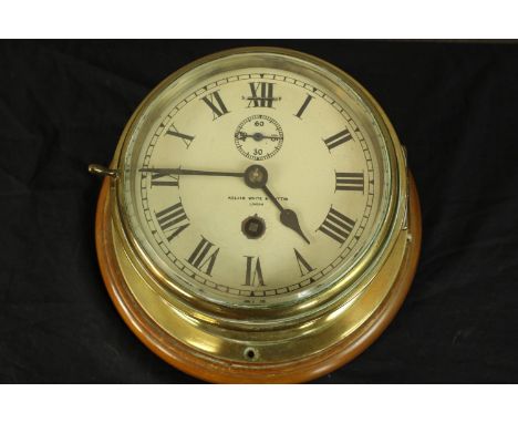 A 19th century brass cased ship's clock with white enamel dial stamped Kelvin White and Sutton. With key. From the Dardanus, 