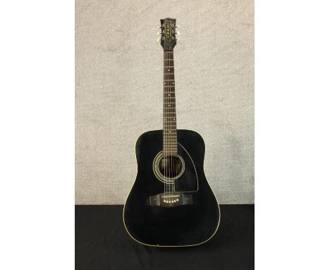A vintage Eko acoustic guitar in a black lacquered finish. L.110cm. 