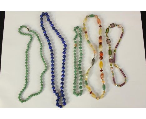 &nbsp;A collection of five necklaces. Two made from jade and one lapis lazuli with a 9ct gold clasp.&nbsp;The largest measure