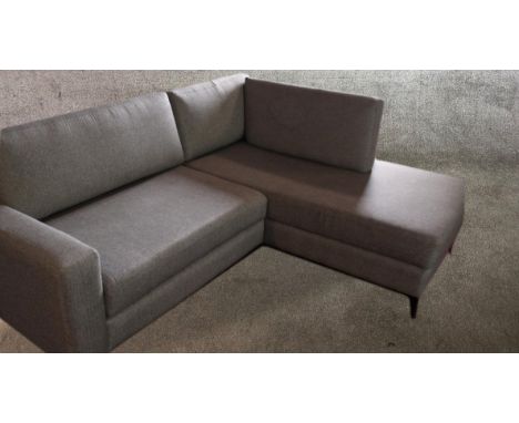 Corner sofa, contemporary in fabric upholstery on metal supports. W.225 D.95cm. 