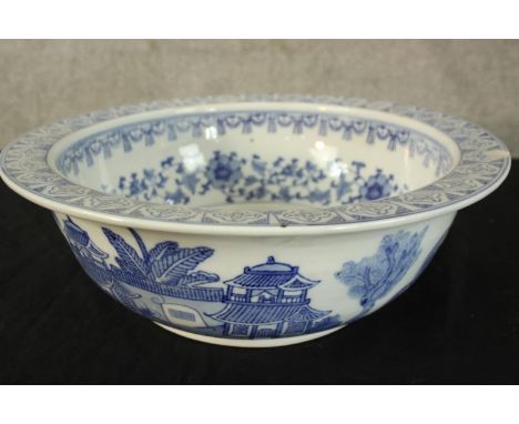 A blue and white decorated ceramic basin. Probably late Victorian. With a light chip in the rim. Dia.35cm. 