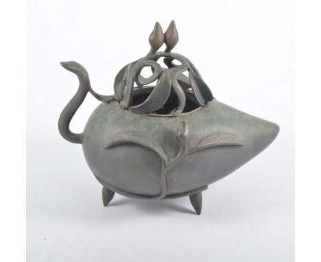 Chinese bronze peach shaped censer, pierced cover, raised on three feet, seal mark in cast to underside, 15cm high.