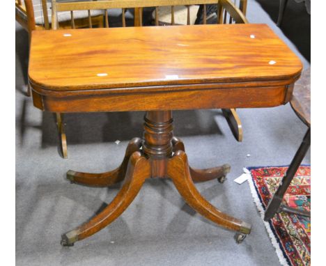A late Georgian rectangular mahogany fold-over card table, on central column support on four splayed legs with brass caps and