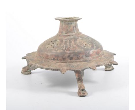 Islamic bronze lamp base, raised on three feet, 21cm diameter.