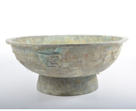 Chinese bronze ritual bowl, 20th century, the exterior cast with masks against bands of repeat motifs, repeated to the pedest