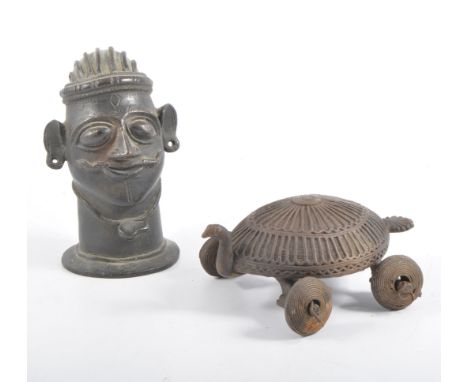 Cast bronze bust of Siva, Hindu deity, 12cm high; together with another cast metal sculpture on wheels (2).