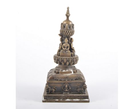 Nepalese style bronze stupa tower, cast with four Buddahs to the column, late 20th century, 29cm.