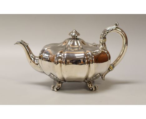 AN EARLY VICTORIAN MELON SHAPED SILVER TEAPOT on four scrolled acanthus supports, acanthus handle and spout, mark for John Mo