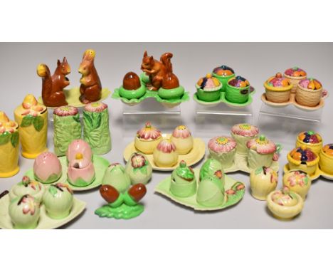 A PARCEL OF NOVELTY CARLTONWARE CRUET SETS of naturalist form including two novelty squirrel examples, fruit examples and lea