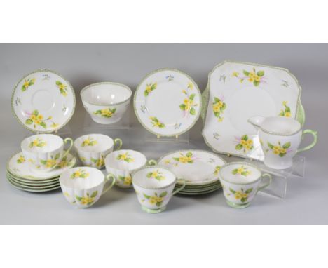 A TWENTY-ONE PIECE SHELLEY 'PRIMROSE' TEA-SET Condition Report correction: hairline crack to small plate not basin (basin is 