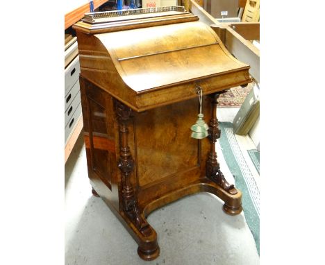 A VICTORIAN WALNUT DAVENPORT DESK having a concealed bank of four drawers to the side and with elevated pull-out tooled-leath