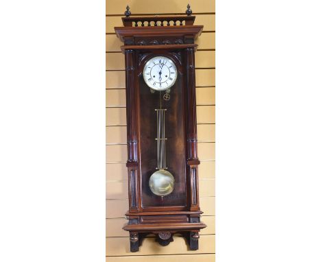 A LARGE GERMAN REPRODUCTION VIENNA WALL-CLOCK with enamel dial bearing Roman numerals within a carved case, 125cms high