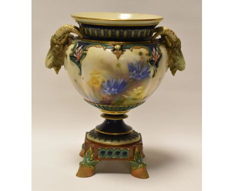 A HADLEY WORCESTER VASE WITH TWIN GOAT-HEAD HANDLES and raised on four hoof feet, painted with flowers, 19cms highCondition R