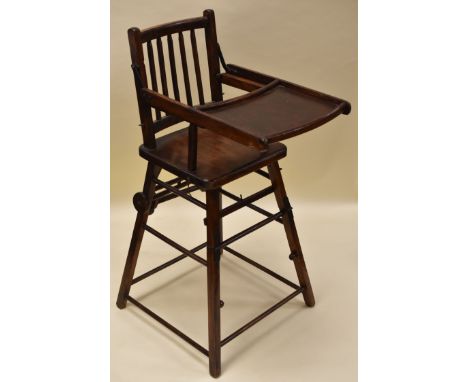A VINTAGE METAMORPHIC HIGH-CHAIR in all-wood, folding to become stroller, 93cms high