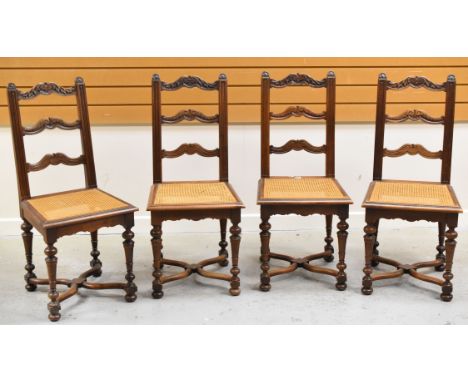 A SET OF FOUR FRENCH CANE WORK CHAIRS having carved ladder backs, carved supports, X-stretcher and caned seats