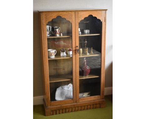 A VINTAGE OAK TWO-DOOR GLAZED BOOKCASE, 76cms wide