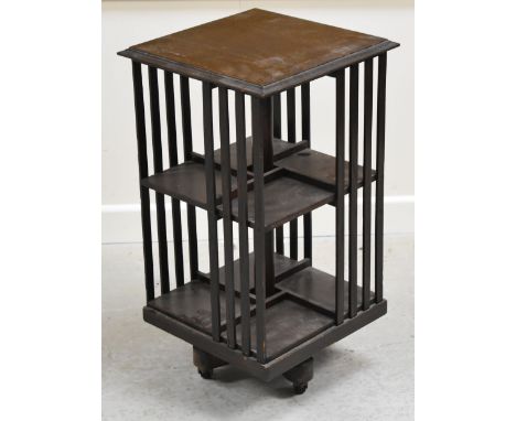 A VINTAGE REVOLVING BOOK STAND on four caster supports, 39 x 70cms