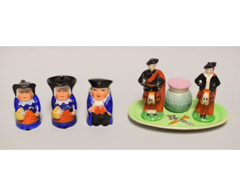 A NOVELTY CARLTONWARE SCOTTISH HIGHLANDER CRUET comprising figural salt and pepperette with thistle mustard-pot, together wit