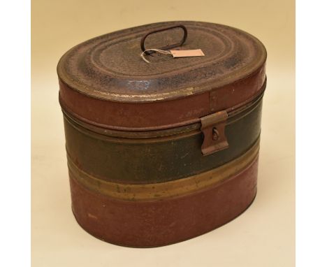 A VINTAGE PAINTED TIN HAT BOX of oval form with clasp and original handle, painted in green and red stripes, 37cms wide
