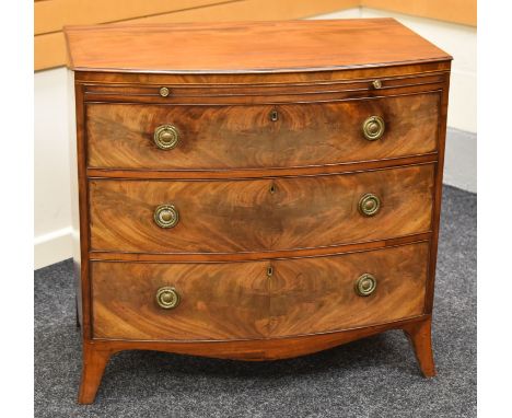 A GOOD TURN OF THE CENTURY BOW FRONT MAHOGANY CHEST OF DRAWERS of three graduated drawers and pull out slide all with brass f