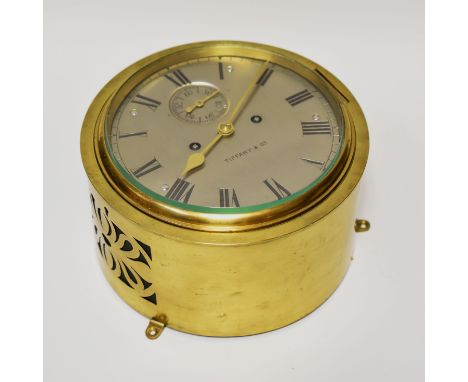 A RARE LATE NINETEENTH CENTURY SHIP'S BELL STRIKING BULKHEAD CLOCK having a silvered dial signed Tiffany & Co, Roman arrow nu