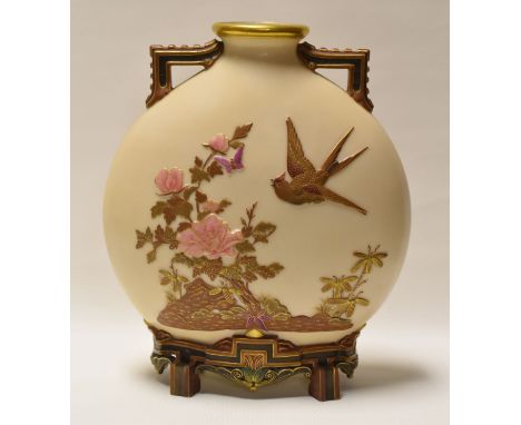 A ROYAL WORCESTER MOON FLASK having twin handles and raised on four feet in ivory ground and decorated in relief in the Orien