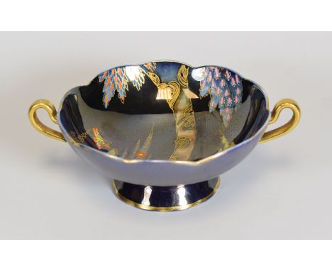 A CARLTONWARE TWIN-HANDLED FOOTED DISH of lobed circular form, with purple lustre reserve and with interior scene of willow t