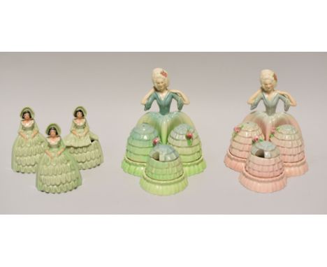 THREE CARLTONWARE CRINOLINE DRESS FIGURAL CRUETS comprising a matching pair in differing glazes and a three piece smaller exa