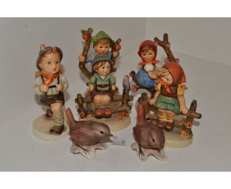A Goebel figure, Girl on a Branch; another similar, Boy on a Branch; a pair of Goebel models, Wrens; a Goebel figure, Schoolb