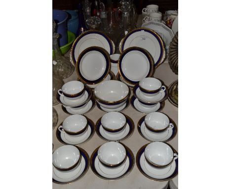 A Mintons ten-setting tea service, gilded band of foliage above cobalt blue banding, pattern no. 14095, comprising a pair of 