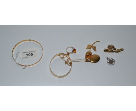 A yellow metal wristwatch; a silver and amber ring, marked 925, 5g gross; a 9ct rolled gold bangle, 10.4 gross; a silver Cana