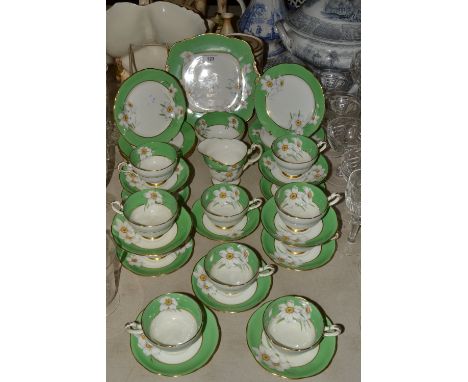 A Paragon Narcissus pattern twelve-setting tea service, pattern no. F1957, comprising sandwich plate, tea plates, cups and sa