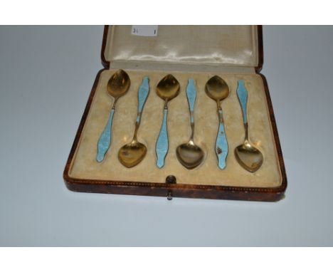 A set of six enamel and EPNS coffee spoons, gilt petal shaped bowls, enamelled in powder blue with birds and foliage, cased, 