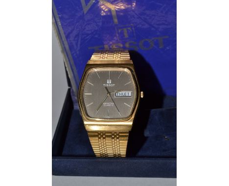 A Tissot Seastar quartz wrist watch, shaped grey dial, white baton markers day date apertures, centre seconds, boxed