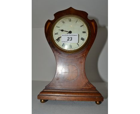 An Edwardian mahogany shaped balloon clock, the 8cm white enamel dial painted with Roman numerals, inlaid with a roundel and 
