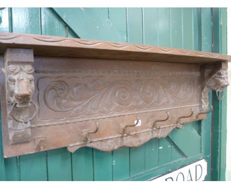 Carved oak bracket shelf coat hook with lion head supports 