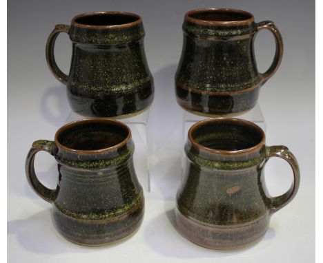 Four Ray Finch Winchcombe Pottery tenmoku glazed mugs, each with yellow specked detail to the glaze, impressed personal seal 