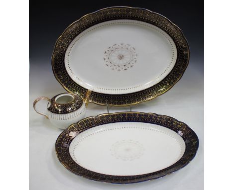 A graduated pair of Meissen oval serving dishes, 19th century, each with gilt overlaid cobalt blue rim, lengths 53cm and 47cm