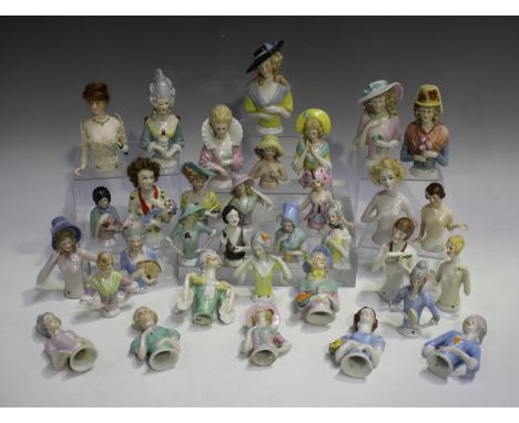 Thirty-three assorted Continental porcelain half-dolls, late 19th and early 20th century, modelled in a variety of poses and 