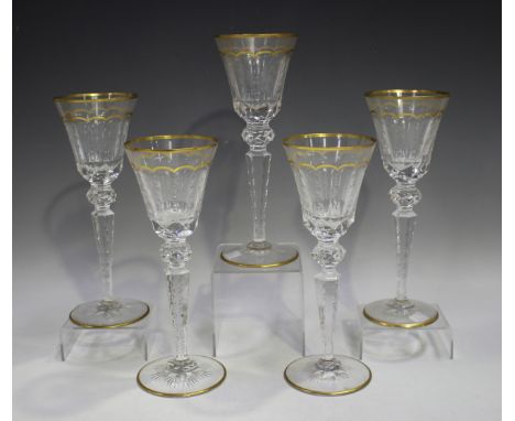 A set of five St Louis Excellance crystal wine glasses with gilt scalloped detail and faceted cuts, acid etched factory mark 