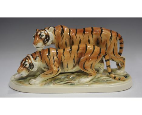 A Hertwig & Co Katzhütte porcelain model of two tigers, on an oval base, green printed mark to base, length 37.5cm.Buyer’s Pr