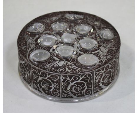 A Lalique Roger pattern circular dish and cover, post-1945, the clear glass with brown staining, moulded with birds amidst fr