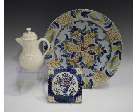 A London Delft circular dish, circa 1740, polychrome painted with a stylized central foliate medallion, the rim with foliate 