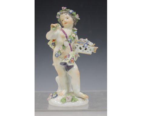 A Meissen porcelain cherub figure allegorical of Spring, late 18th/19th century, adorned with a floral headdress and garland,