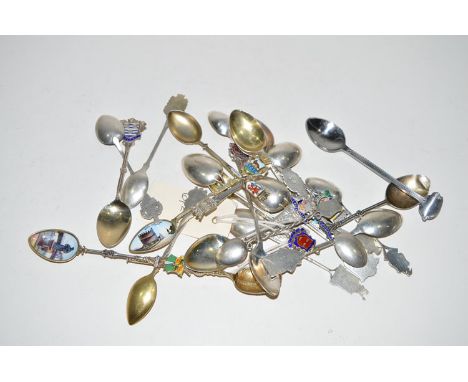 A quantity of silver commemorative teaspoons, many with enamel finials.