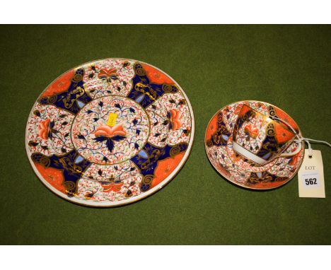 An early 19th Century Davenport cup and saucer decorated in the Imari colours, together with a similar plate marked "1392" on