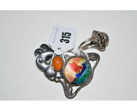 A white metal Arts & Crafts enamel galleon pattern brooch; a green set white metal ring of scrolling design; and an amber set