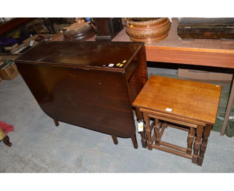 A mahogany drop leaf table fitted gate action; together with an oak nest of three tables.